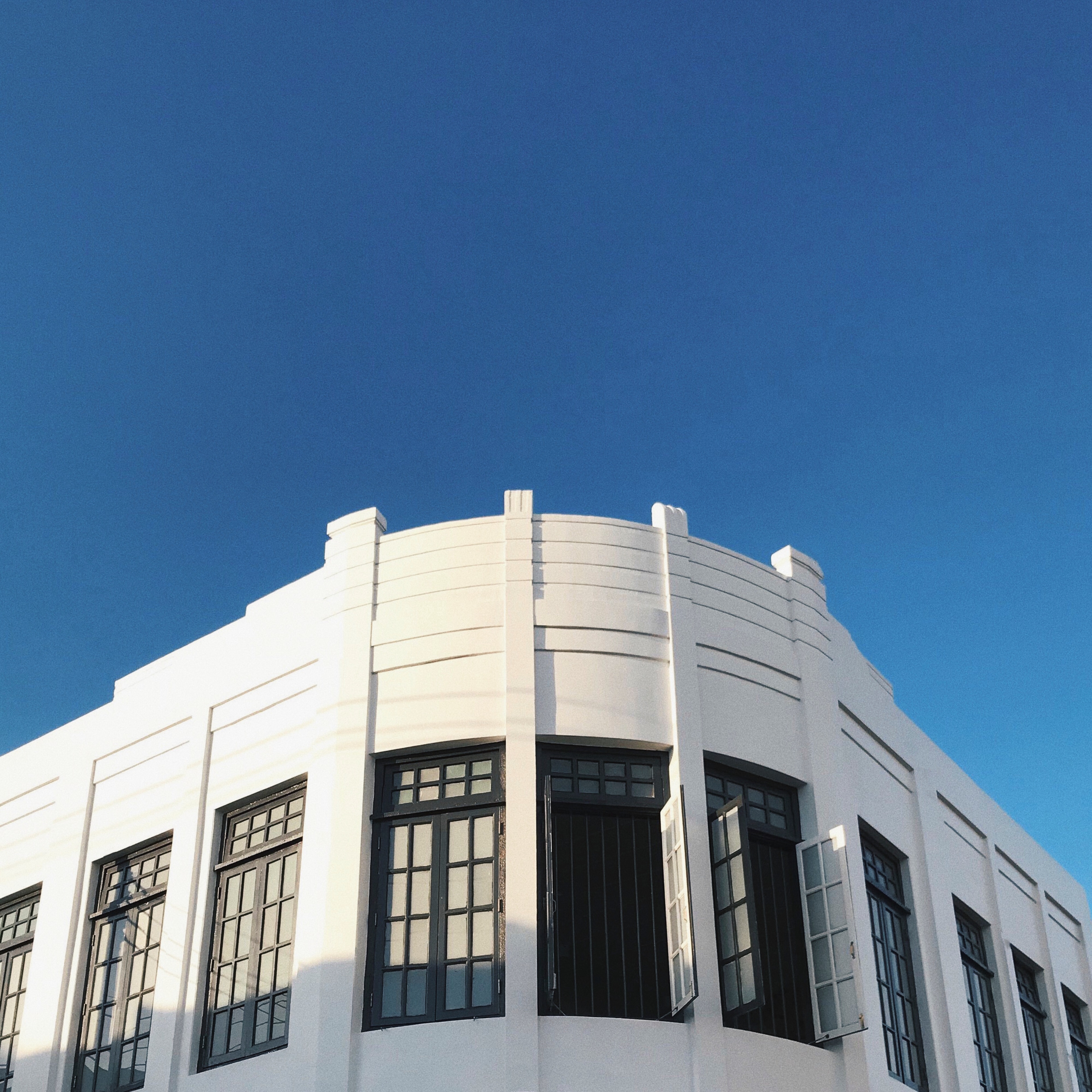 Modern building facade against clear blue sky